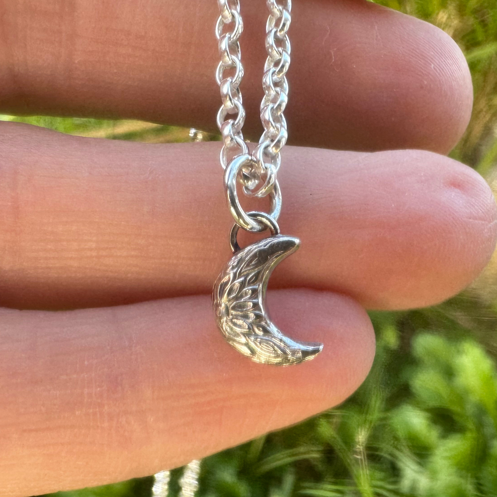 
                  
                    Handmade rustic crescent moon charm on hand 
                  
                