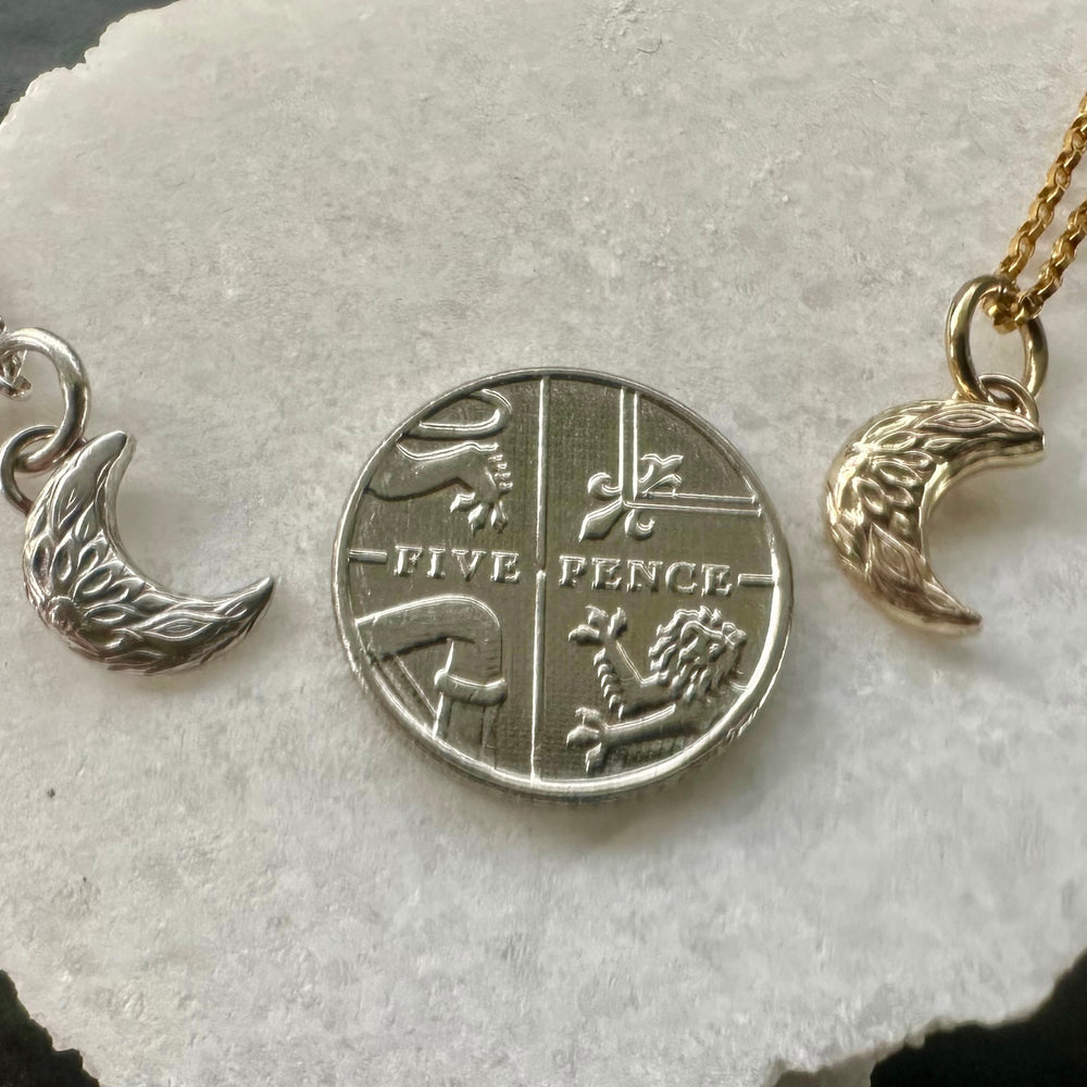 
                  
                    Handmade crescent moon charm size comparison against 5 pence piece
                  
                